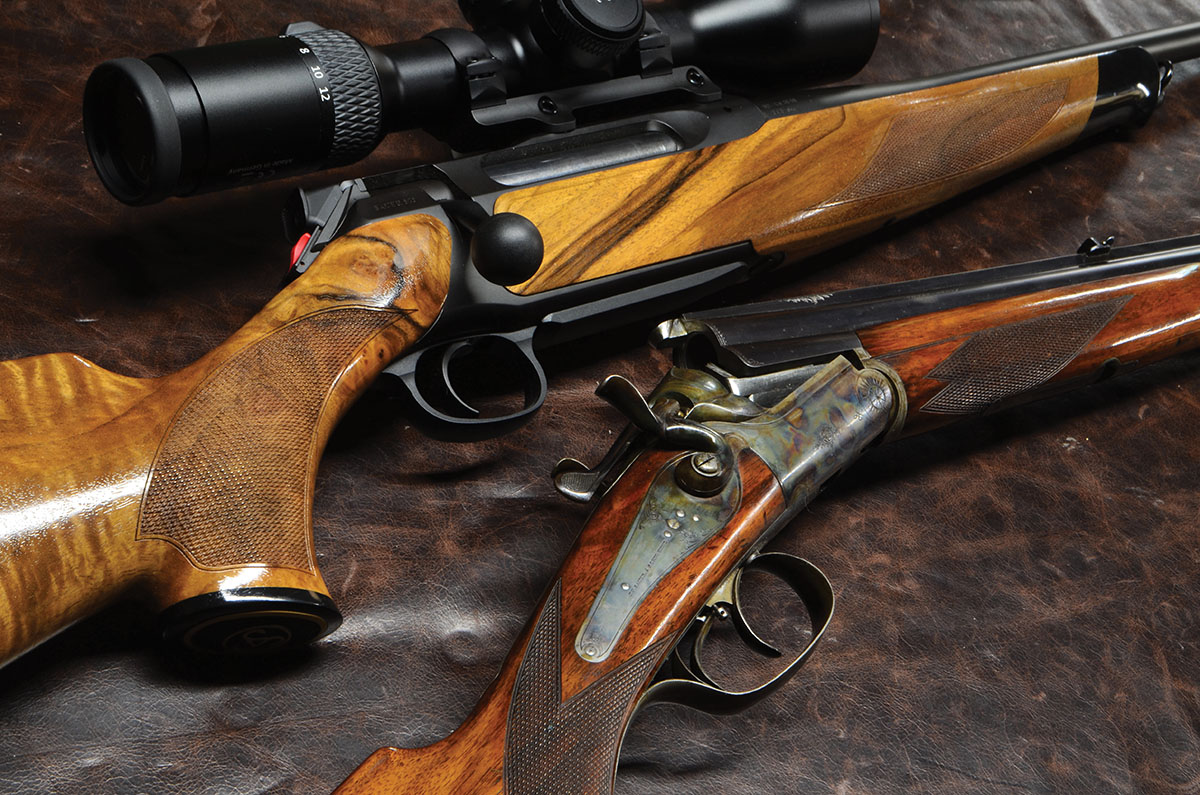 A Sauer Model 505 (top) beside an over/under combination gun with external hammers, built by the company in 1913. It has a 274-year tradition of high quality.